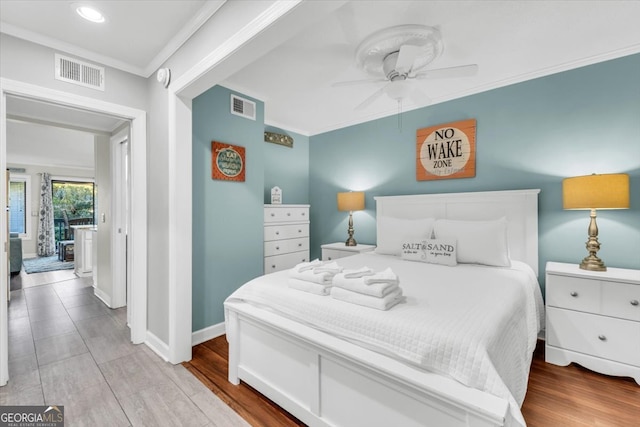 bedroom featuring crown molding, ceiling fan, and light hardwood / wood-style floors