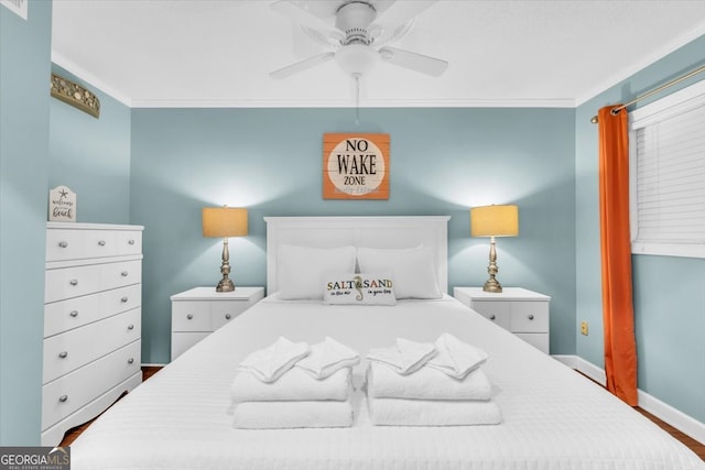 bedroom with hardwood / wood-style flooring, ceiling fan, and ornamental molding