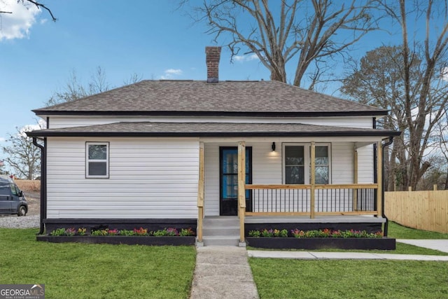 bungalow with a front yard and a porch