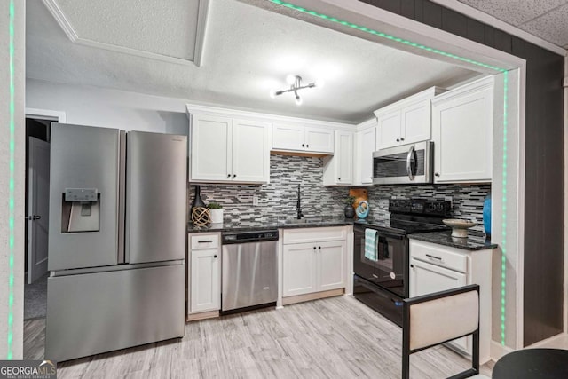 kitchen with stainless steel appliances, light hardwood / wood-style floors, sink, and white cabinets