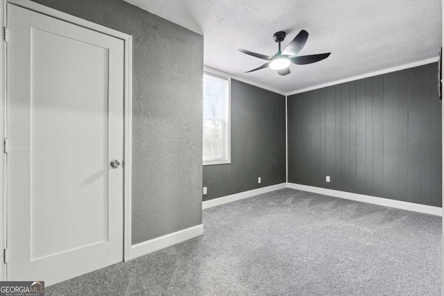 unfurnished bedroom featuring carpet floors, a textured ceiling, and ceiling fan