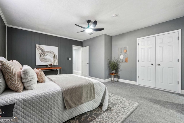 carpeted bedroom featuring ceiling fan, ornamental molding, a closet, and a textured ceiling