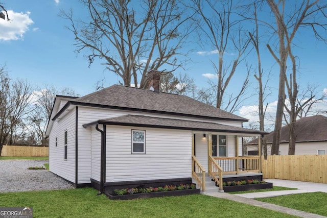 view of front of house featuring a front yard and covered porch