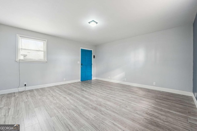 spare room featuring light wood-type flooring