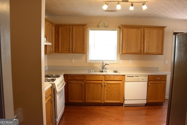 3013 Pommel Ct, Conyers, GA 30013 - kitchen with white appliances, custom range hood, a textured ceiling, light countertops, and wood finished floors