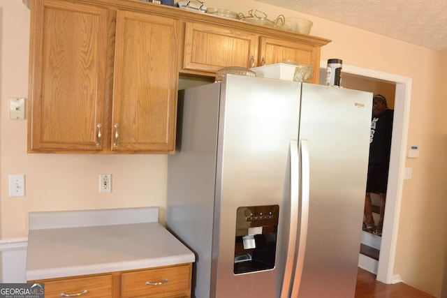 3013 Pommel Ct, Conyers, GA 30013 - kitchen featuring stainless steel fridge, light countertops, and brown cabinetry