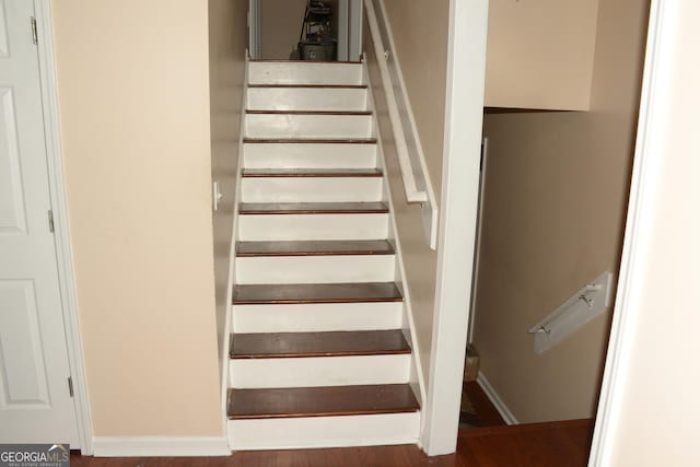 stairway featuring hardwood / wood-style floors