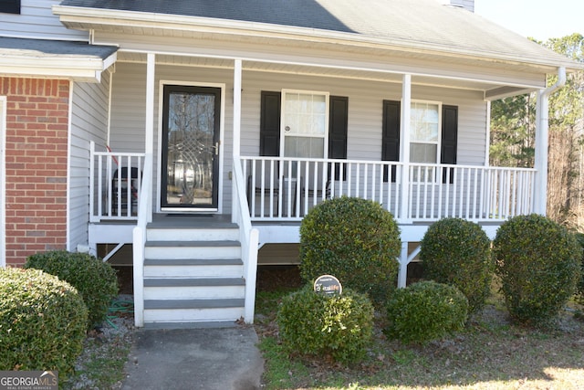 3013 Pommel Ct, Conyers, GA 30013 - property entrance with covered porch, a chimney, and a shingled roof