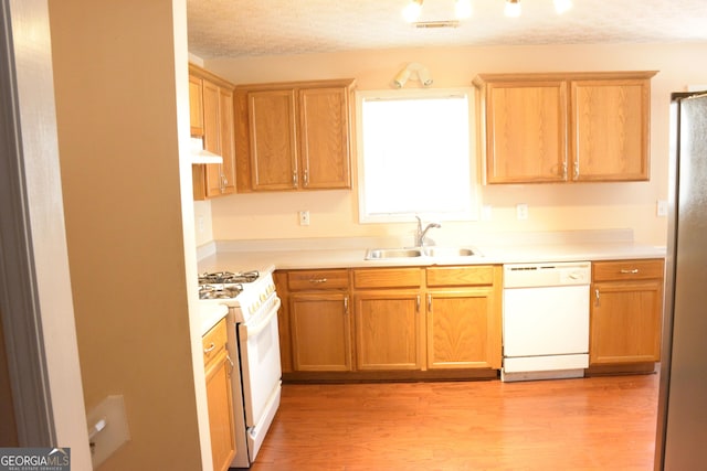 3013 Pommel Ct, Conyers, GA 30013 - kitchen with white appliances, light wood-type flooring, light countertops, a textured ceiling, and custom exhaust hood