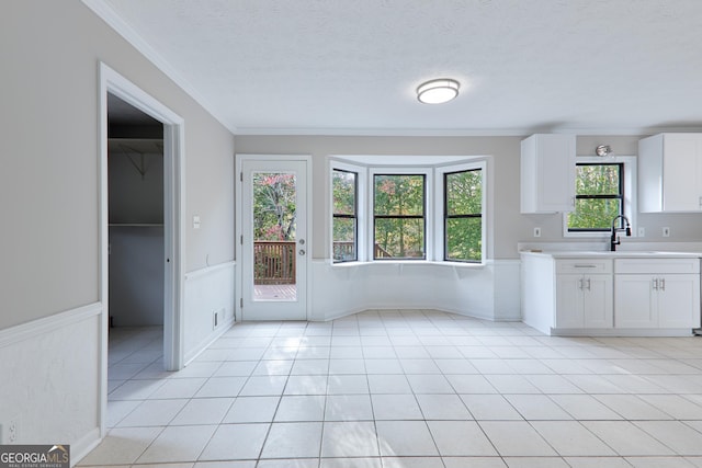 kitchen featuring white cabinetry, sink, and a textured ceiling