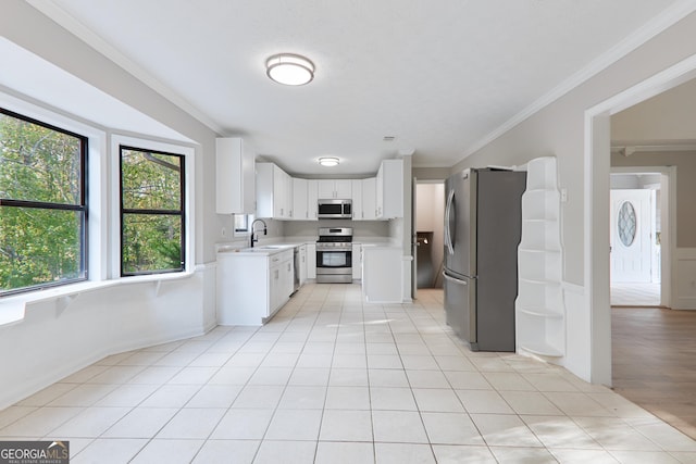 kitchen with sink, crown molding, light tile patterned floors, stainless steel appliances, and white cabinets