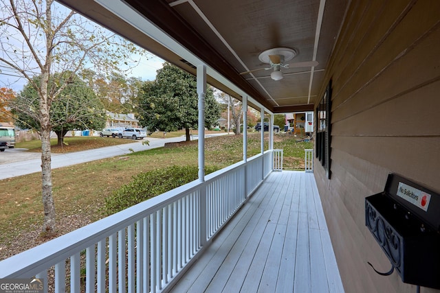 wooden deck with ceiling fan and a porch