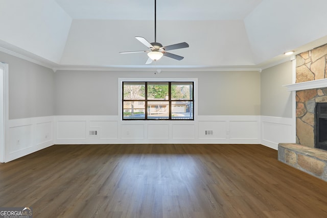 unfurnished living room featuring a fireplace, dark hardwood / wood-style flooring, ceiling fan, a raised ceiling, and crown molding