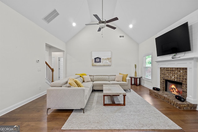 living room featuring ceiling fan, a brick fireplace, high vaulted ceiling, and dark hardwood / wood-style flooring