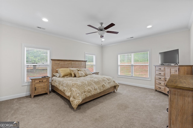 carpeted bedroom with crown molding and ceiling fan