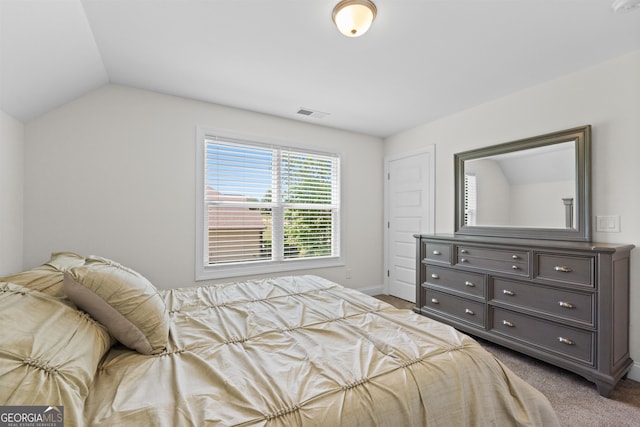 carpeted bedroom featuring lofted ceiling