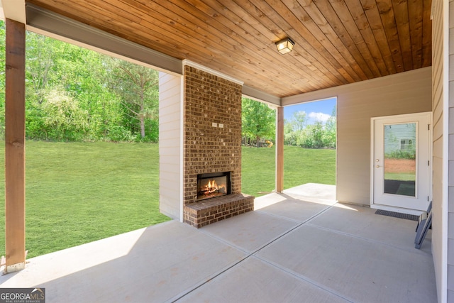 view of patio with an outdoor brick fireplace