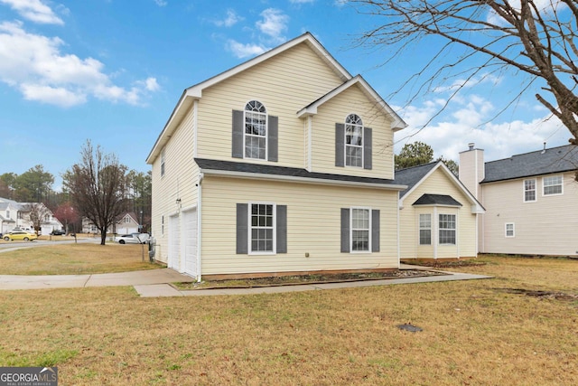 view of front facade featuring a garage and a front yard