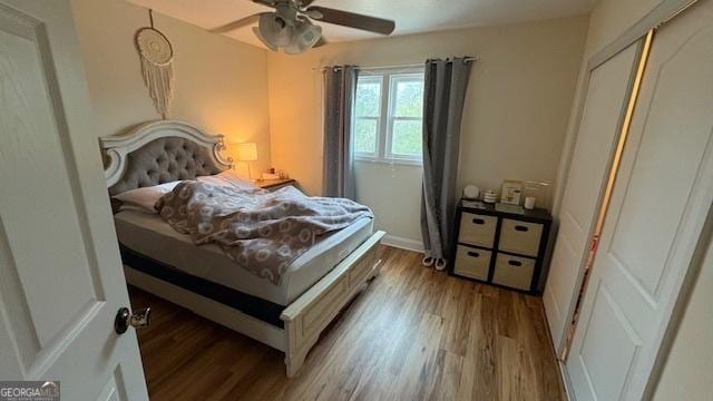 bedroom with light hardwood / wood-style floors, a closet, and ceiling fan