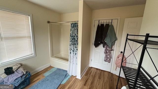 bathroom featuring wood-type flooring and a shower with shower curtain