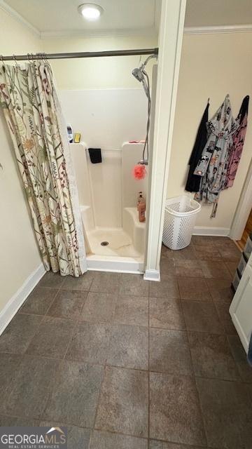 bathroom with walk in shower and crown molding