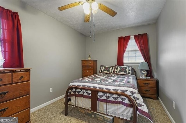 carpeted bedroom featuring a textured ceiling and ceiling fan