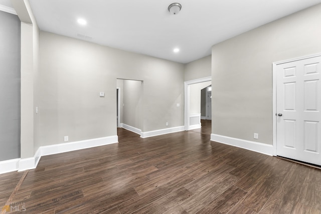 spare room with dark hardwood / wood-style floors