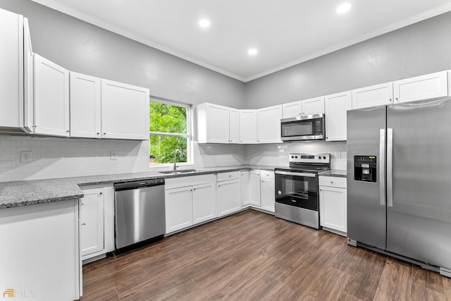 kitchen featuring sink, white cabinetry, appliances with stainless steel finishes, dark hardwood / wood-style floors, and stone counters