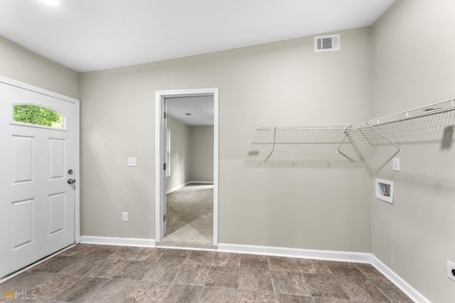 view of carpeted foyer entrance