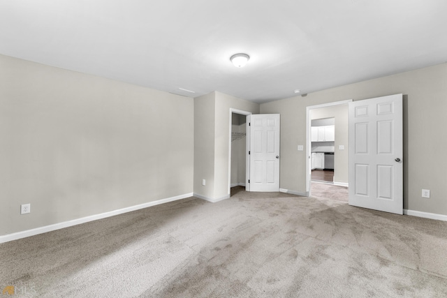 unfurnished bedroom featuring carpet flooring and a closet