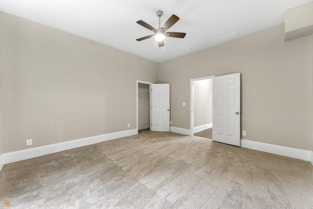 unfurnished bedroom featuring carpet floors, a closet, and ceiling fan