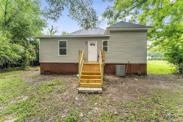 back of house featuring central air condition unit