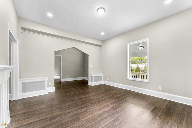 unfurnished living room featuring dark hardwood / wood-style floors