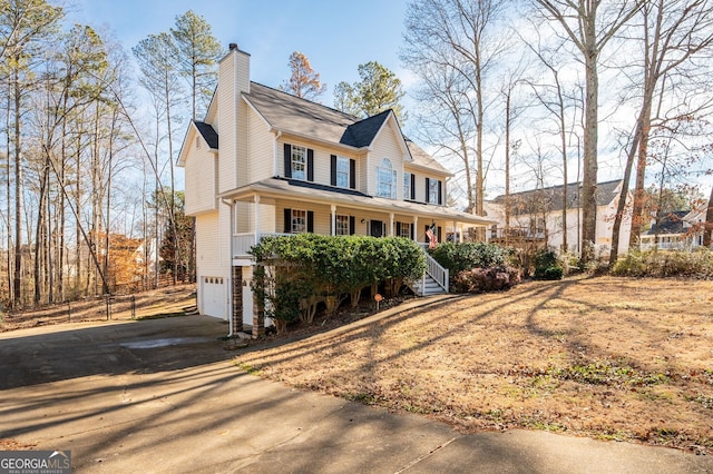 view of front of home featuring a porch and a garage