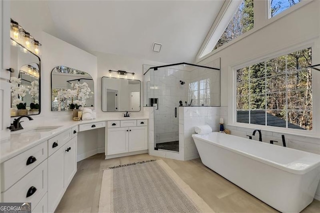 bathroom with shower with separate bathtub, lofted ceiling, and vanity