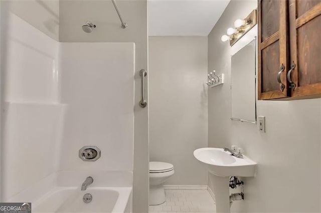 bathroom with tub / shower combination and toilet