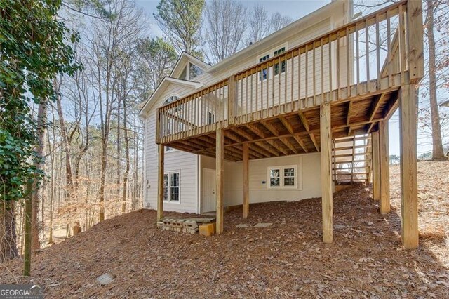 back of house featuring a deck