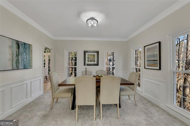 dining area featuring crown molding and light colored carpet