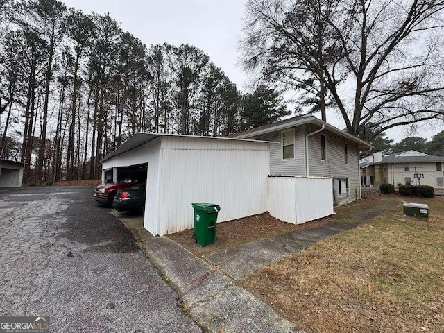 view of property exterior featuring a garage and an outdoor structure