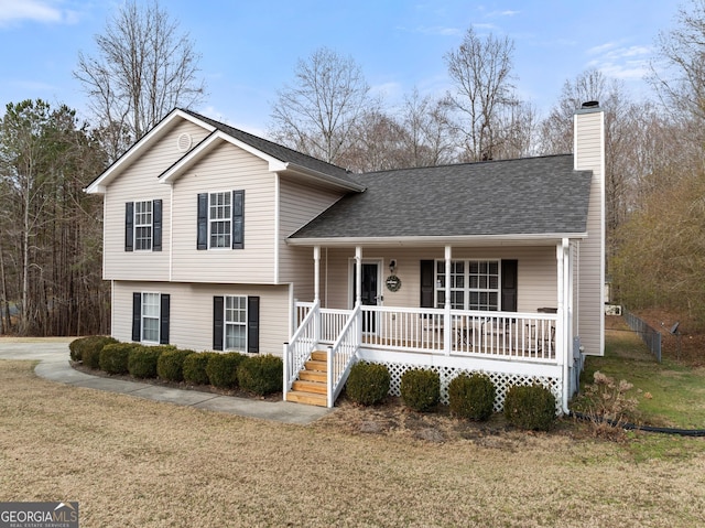 tri-level home with a front lawn and covered porch