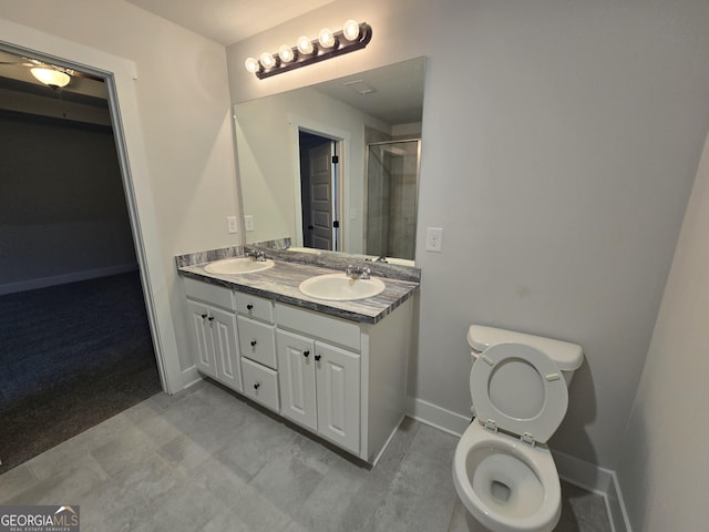 bathroom with walk in shower, vanity, and toilet