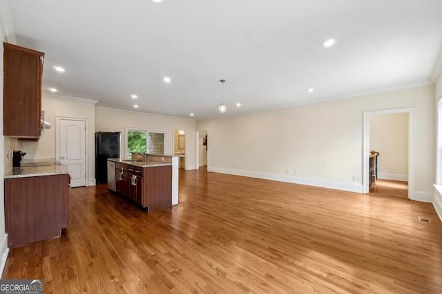 kitchen featuring sink, hardwood / wood-style flooring, a center island, decorative light fixtures, and stainless steel dishwasher