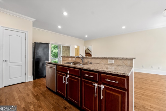 kitchen with sink, light stone counters, wood-type flooring, black refrigerator, and stainless steel dishwasher