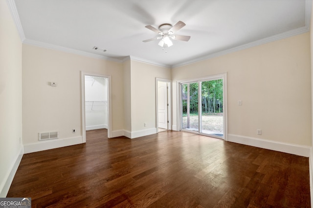 empty room featuring dark hardwood / wood-style flooring, ornamental molding, and ceiling fan