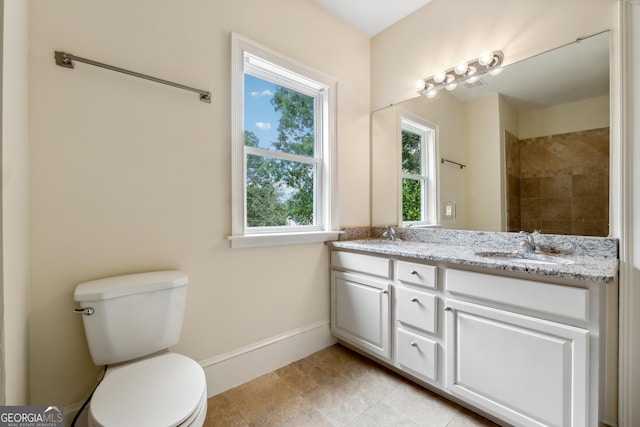 bathroom with vanity, tile patterned floors, and toilet