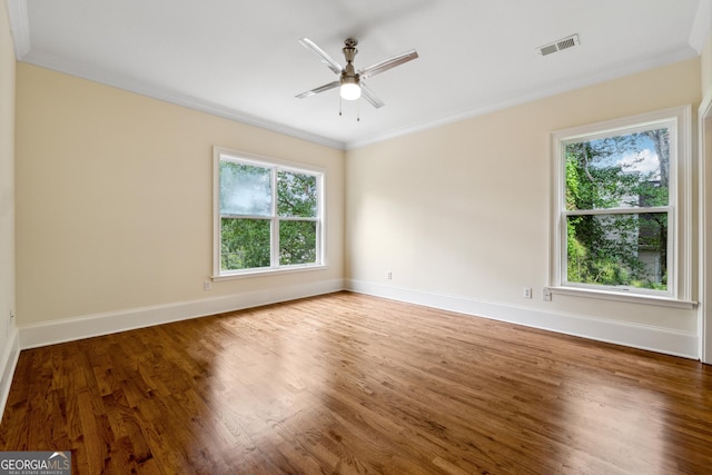 unfurnished room featuring wood-type flooring, ornamental molding, and ceiling fan