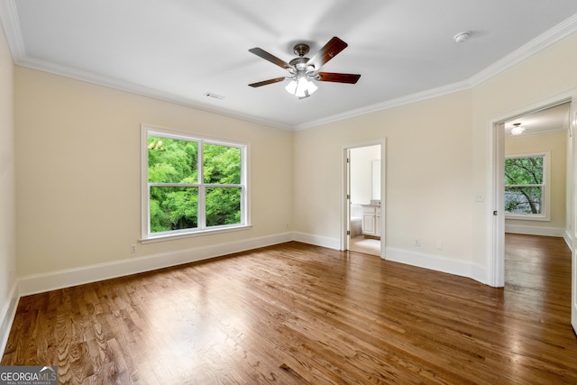 unfurnished room featuring dark hardwood / wood-style flooring, ornamental molding, and ceiling fan