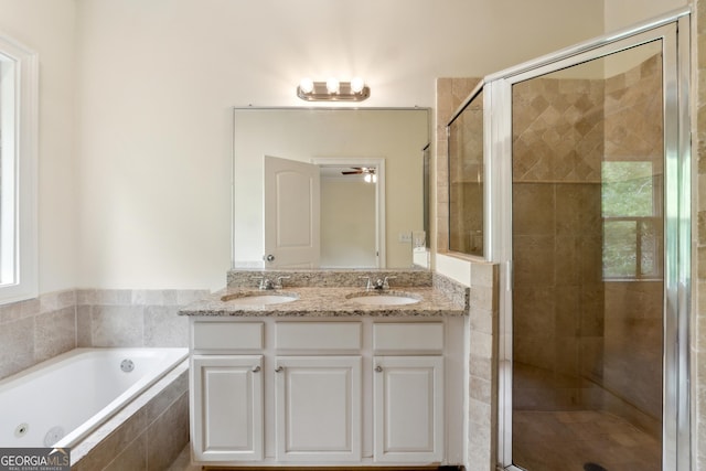 bathroom with vanity and separate shower and tub