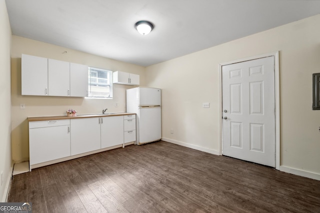 kitchen featuring white fridge, sink, white cabinets, and dark hardwood / wood-style flooring