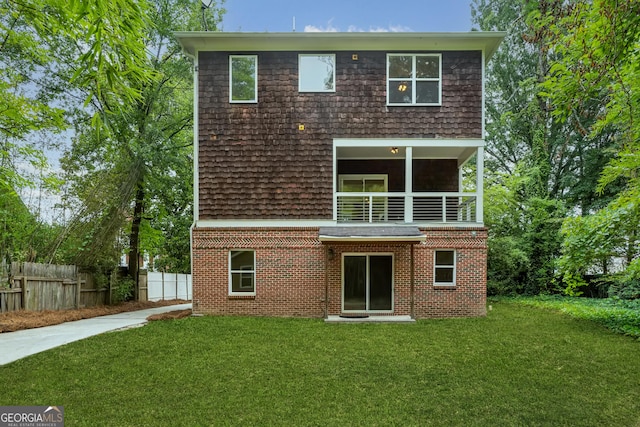 back of house with a lawn